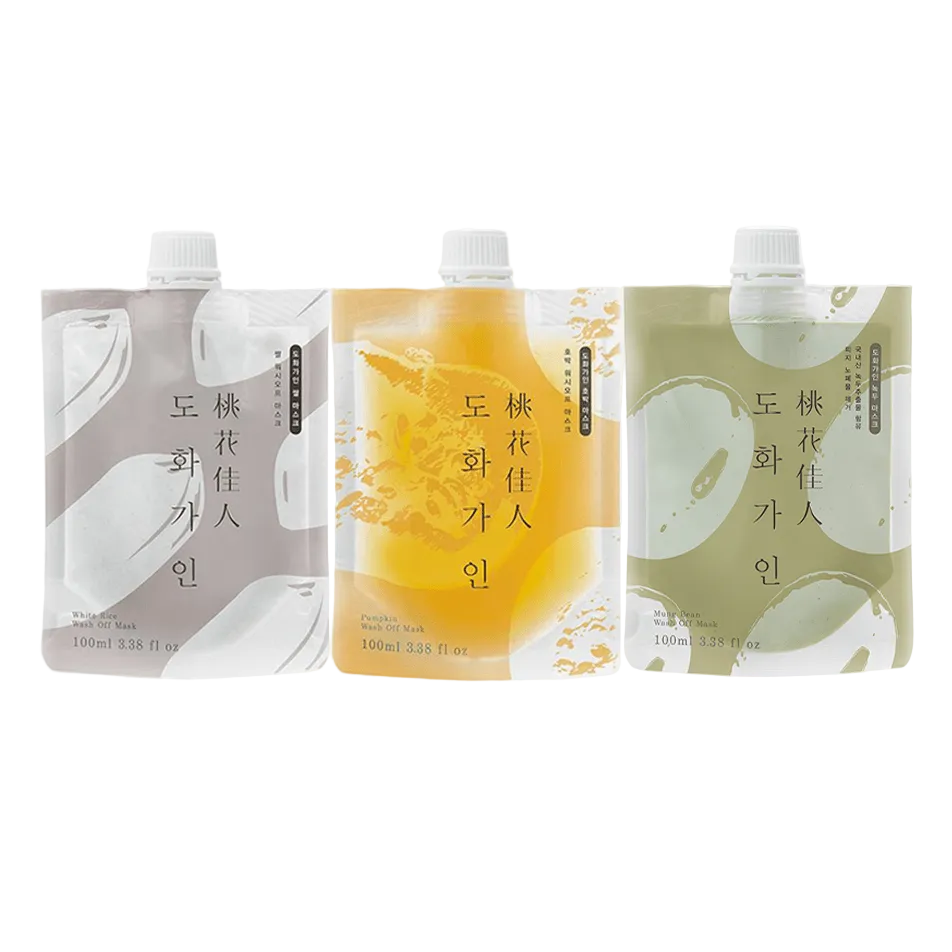 Three 160ml pouches of Dohwa Garden organic fruit juice arranged side by side on a light gray background. The left pouch is light gray with white abstract graphics, the middle pouch is golden yellow with orange abstract graphics, and the right pouch is sage green with white abstract graphics.