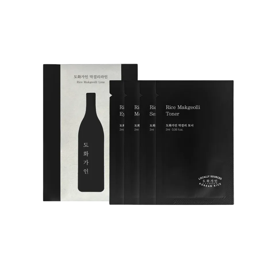 A set of locally sourced rice macadamii toner face mask sachets in black packaging, displayed next to a silver and black outer box on a light gray background.