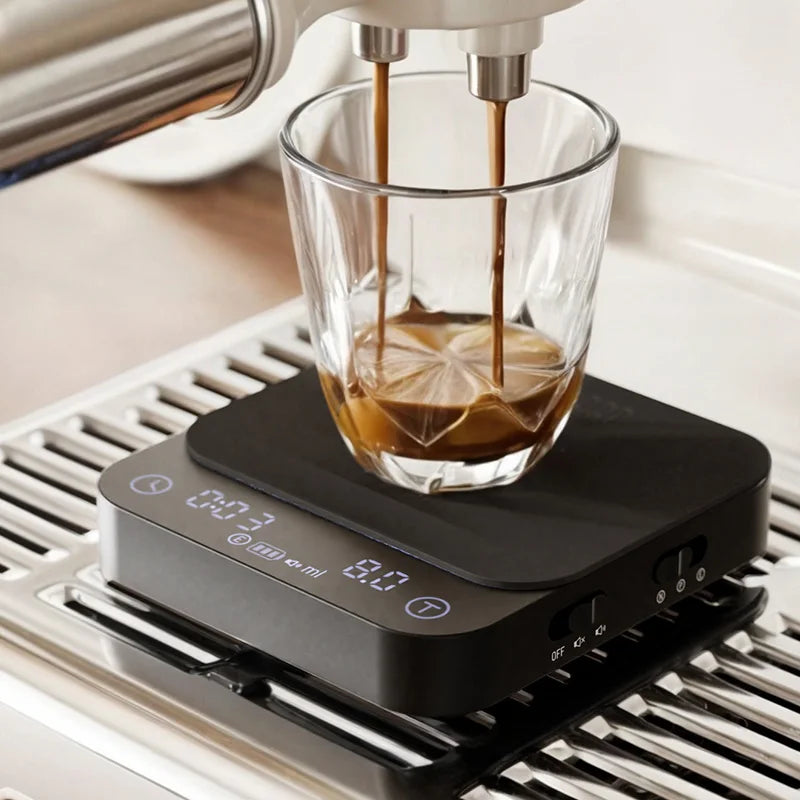 WACACO Exagram Pro coffee scale weighing espresso beneath an espresso machine.